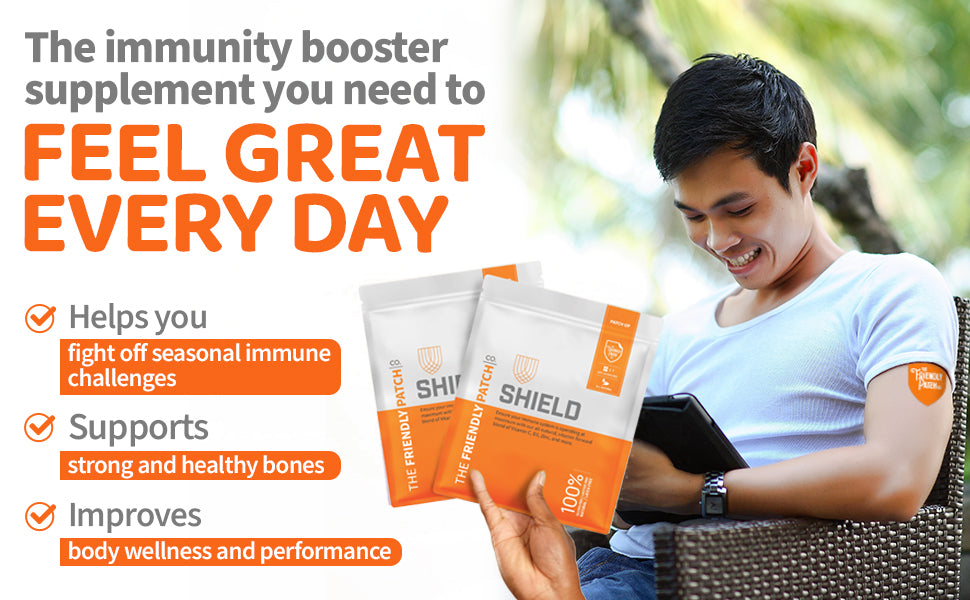 Shield Wellness patch packets, orange and white, held while using phone