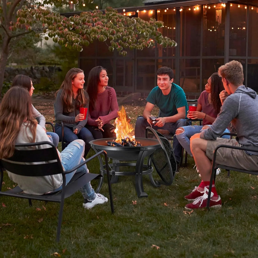 Outdoor black fire pit with mesh screen in use, surrounded by chairs