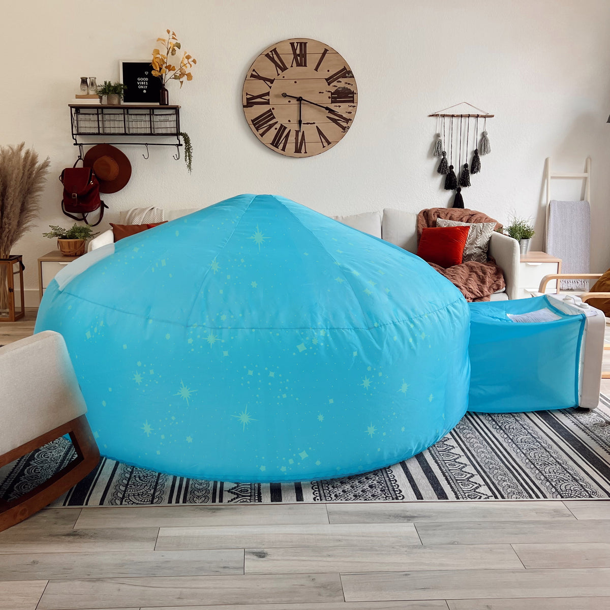 Blue glowing constellation inflatable air fort dome in a living room setting