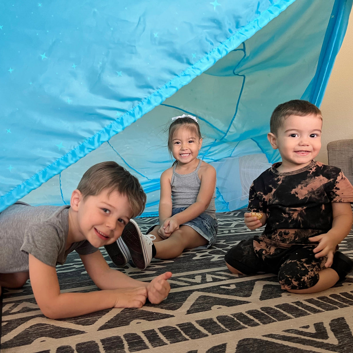 Blue inflatable dome play tent with open door and constellation pattern