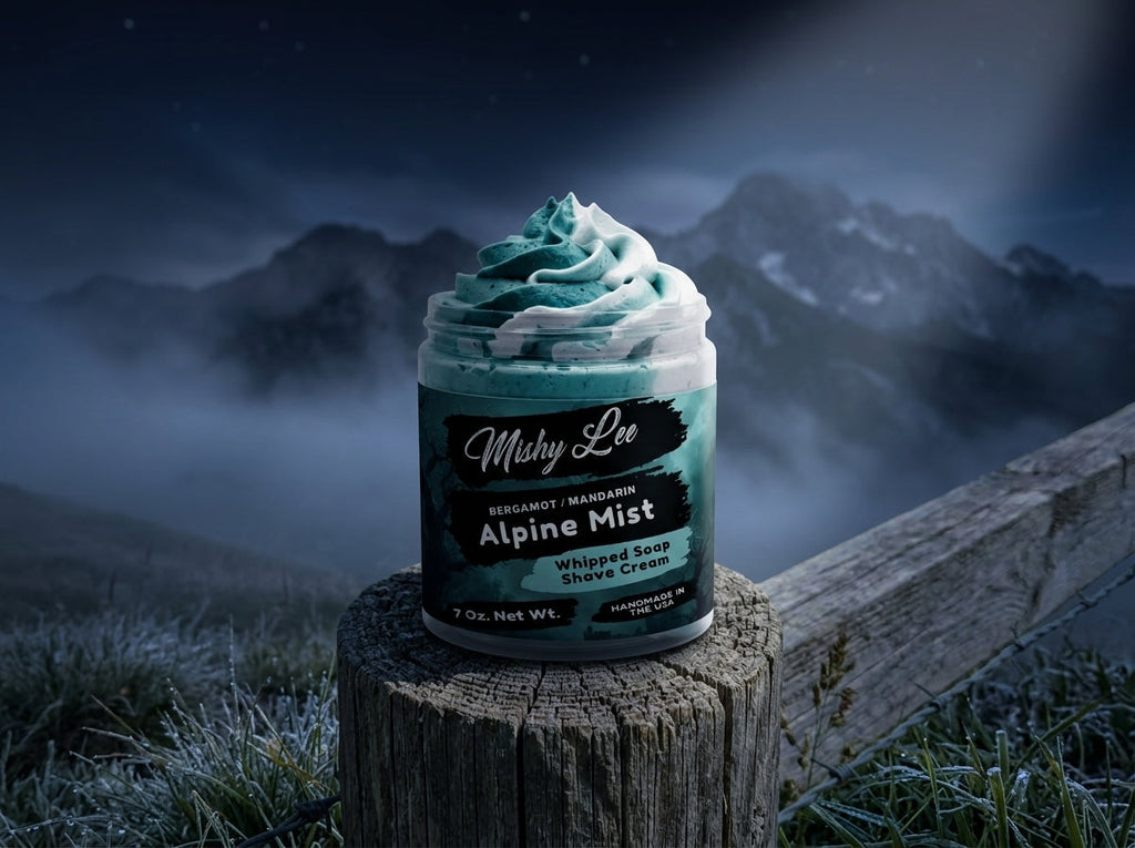 Men’s whipped soap and shave cream jar on tree stump outdoors with misty mountain backdrop.