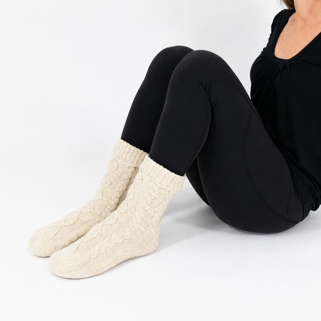Oatmeal slipper socks with chunky cable-knit texture and sherpa cuff