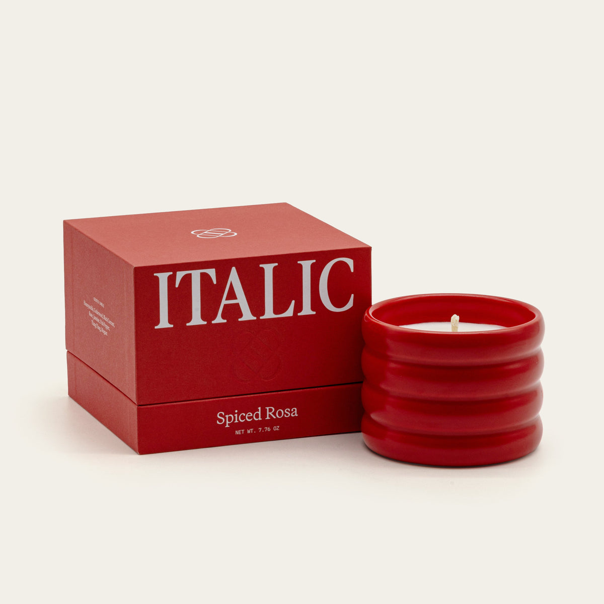 Spiced Rosa soy wax ceramic candle in red ridged holder with lit wick