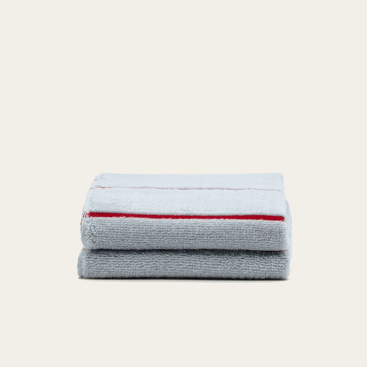 Gray cotton hand towel with two red stripe bands, folded