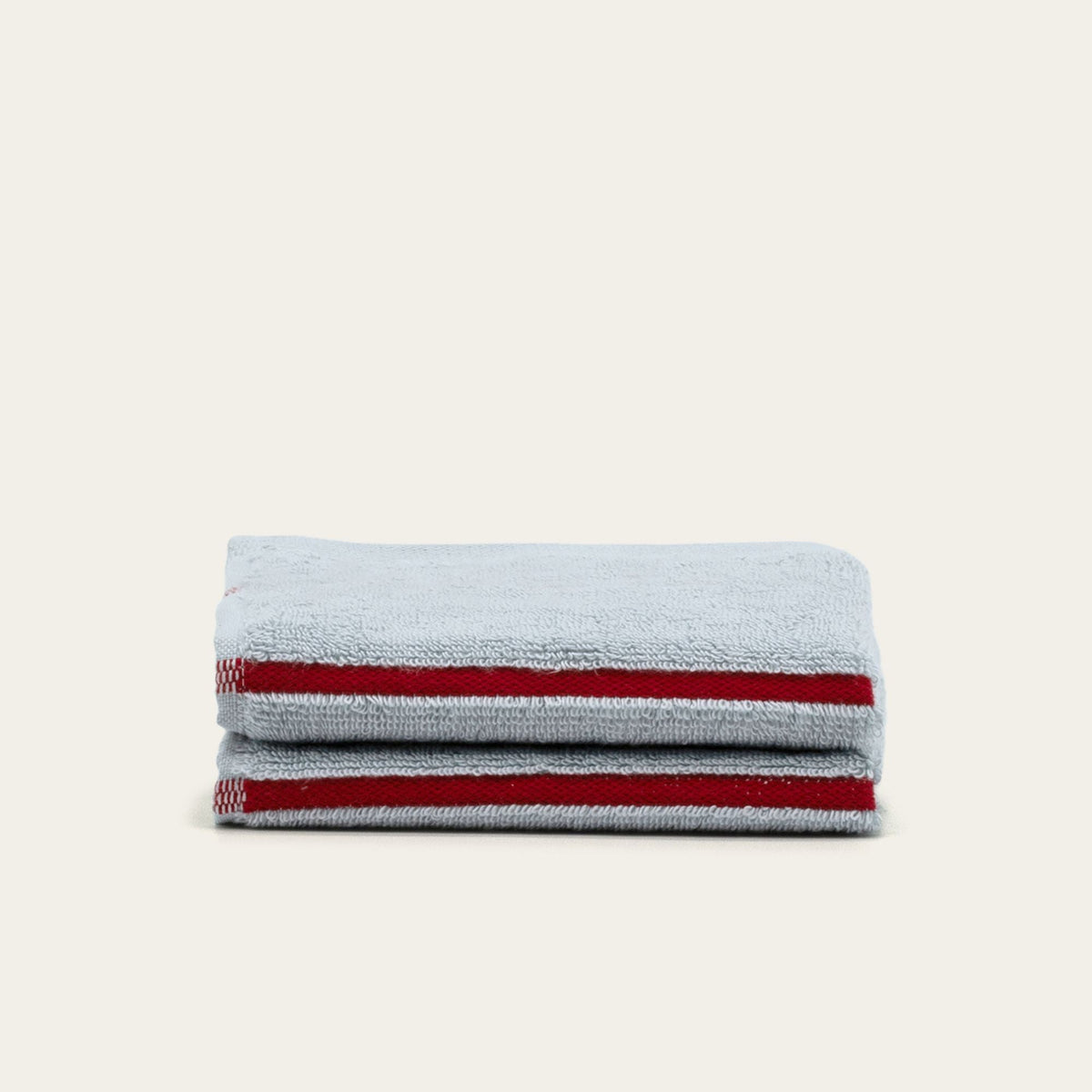Gray cotton bath towel with two red stripe bands, folded