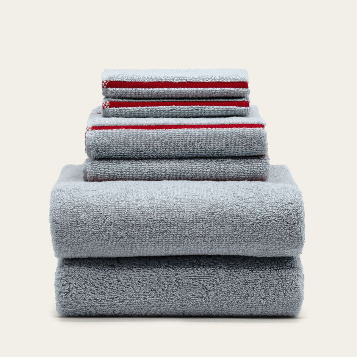 Stack of light gray cotton bath towels, neatly folded