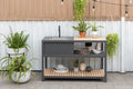 Outdoor kitchen island with single sink, faucet, gray cabinet, wood top and open shelves
