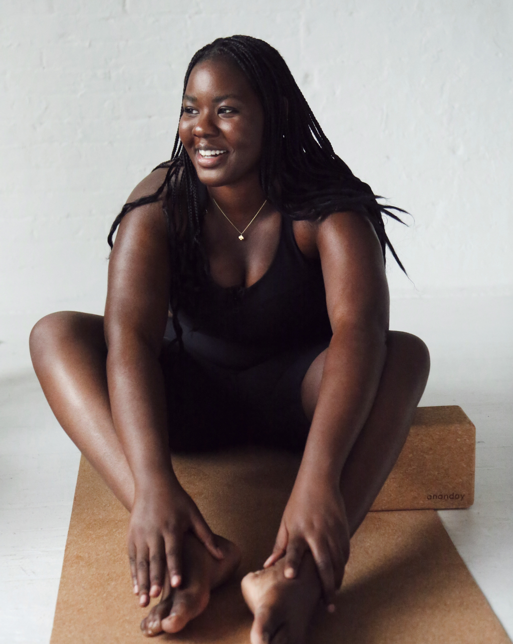 Cork yoga bolster with model seated on it for support