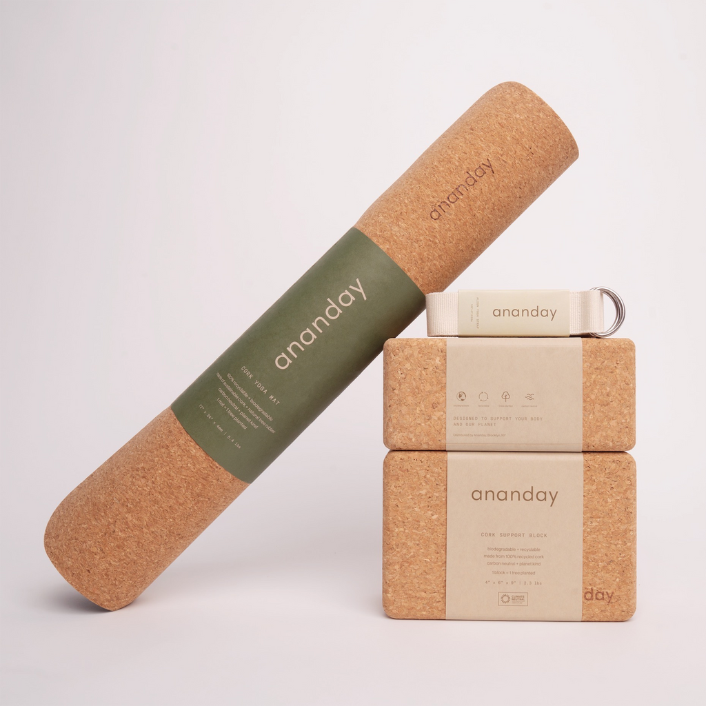 Yoga starter set with cork bolster, two blocks, and tan yoga strap