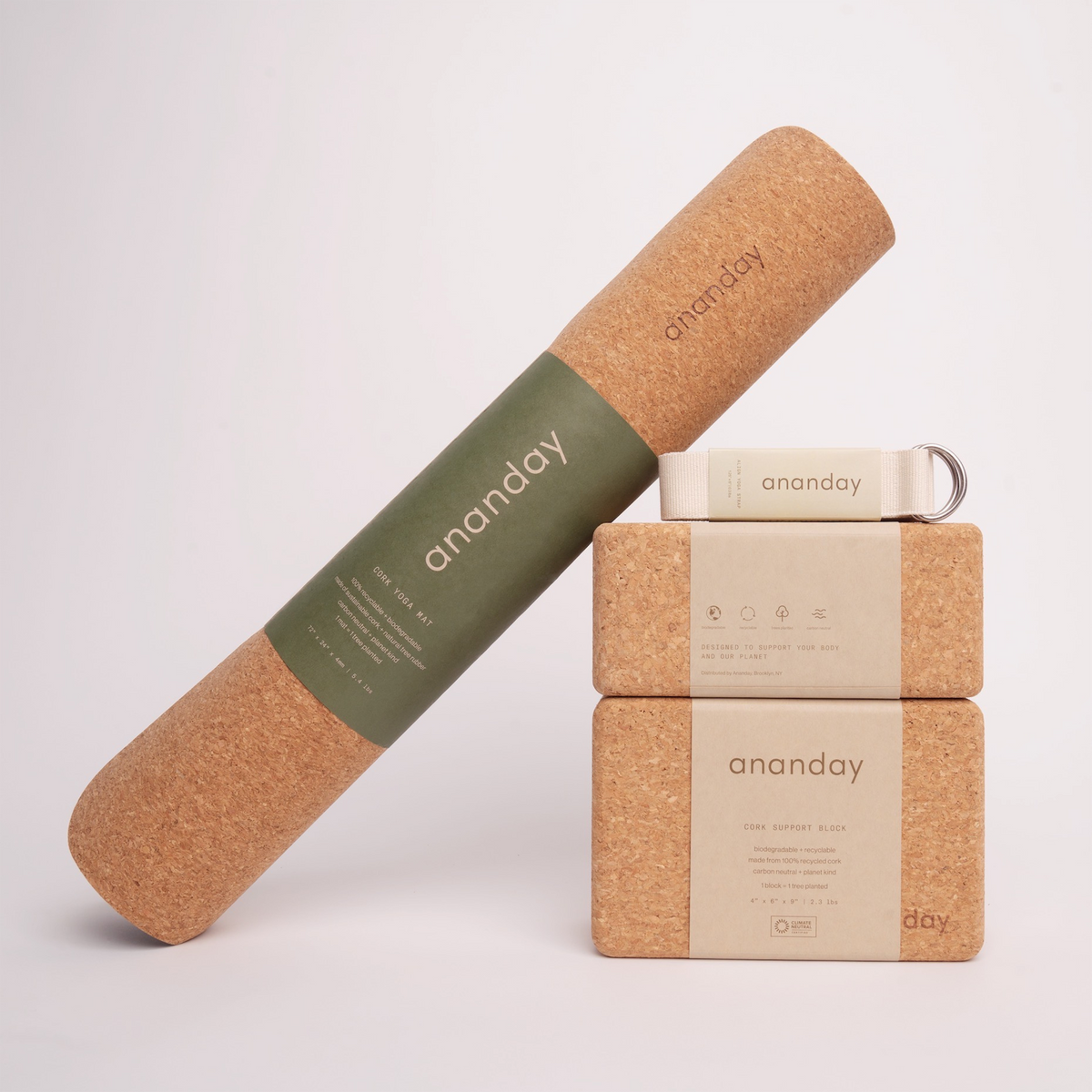 Yoga starter set with cork bolster, two blocks, and tan yoga strap