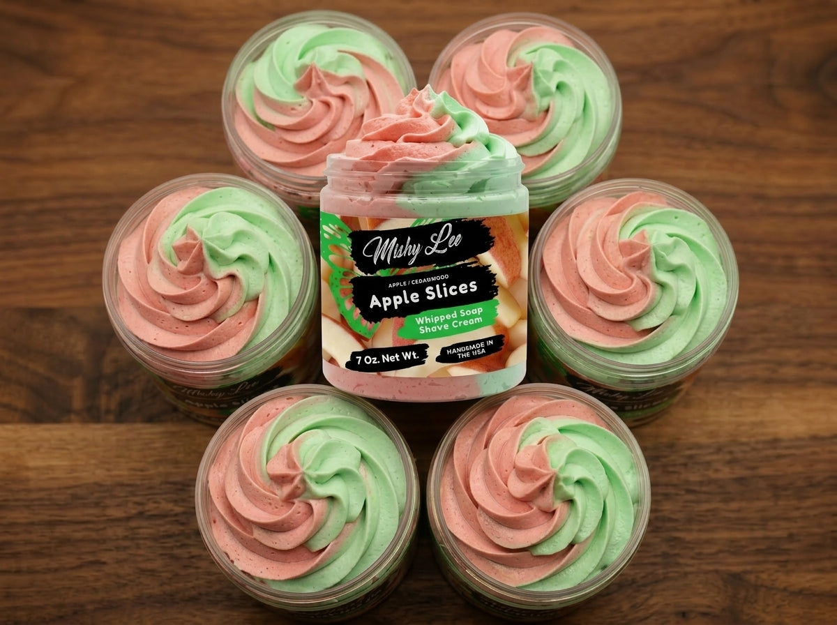 Multiple small containers of pink and green whipped soap rosettes arranged on wood