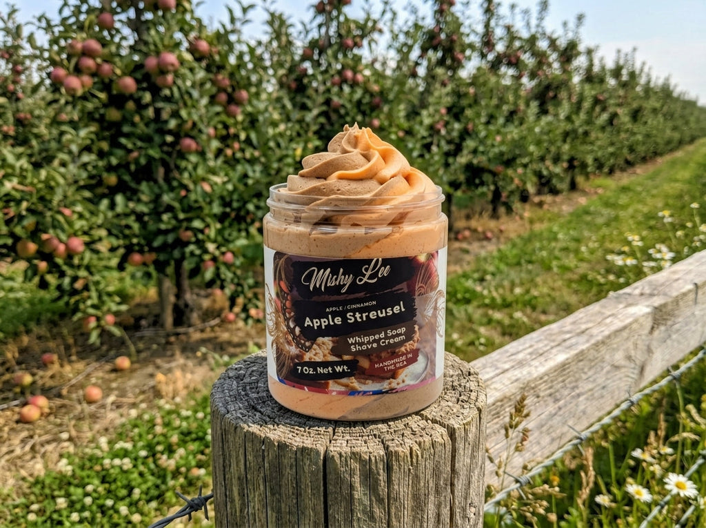 Whipped soap and shave cream jar with beige swirl top on outdoor fence
