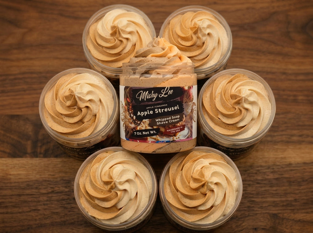 Six jars of beige whipped soap and shave cream arranged around a central jar