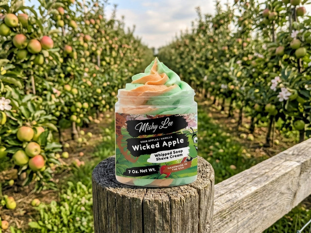 Whipped soap and shave cream jar on a wooden post outdoors with pastel swirl top.