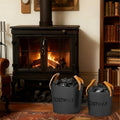 Set of 2 black metal ash buckets with tan leather handles by a fireplace