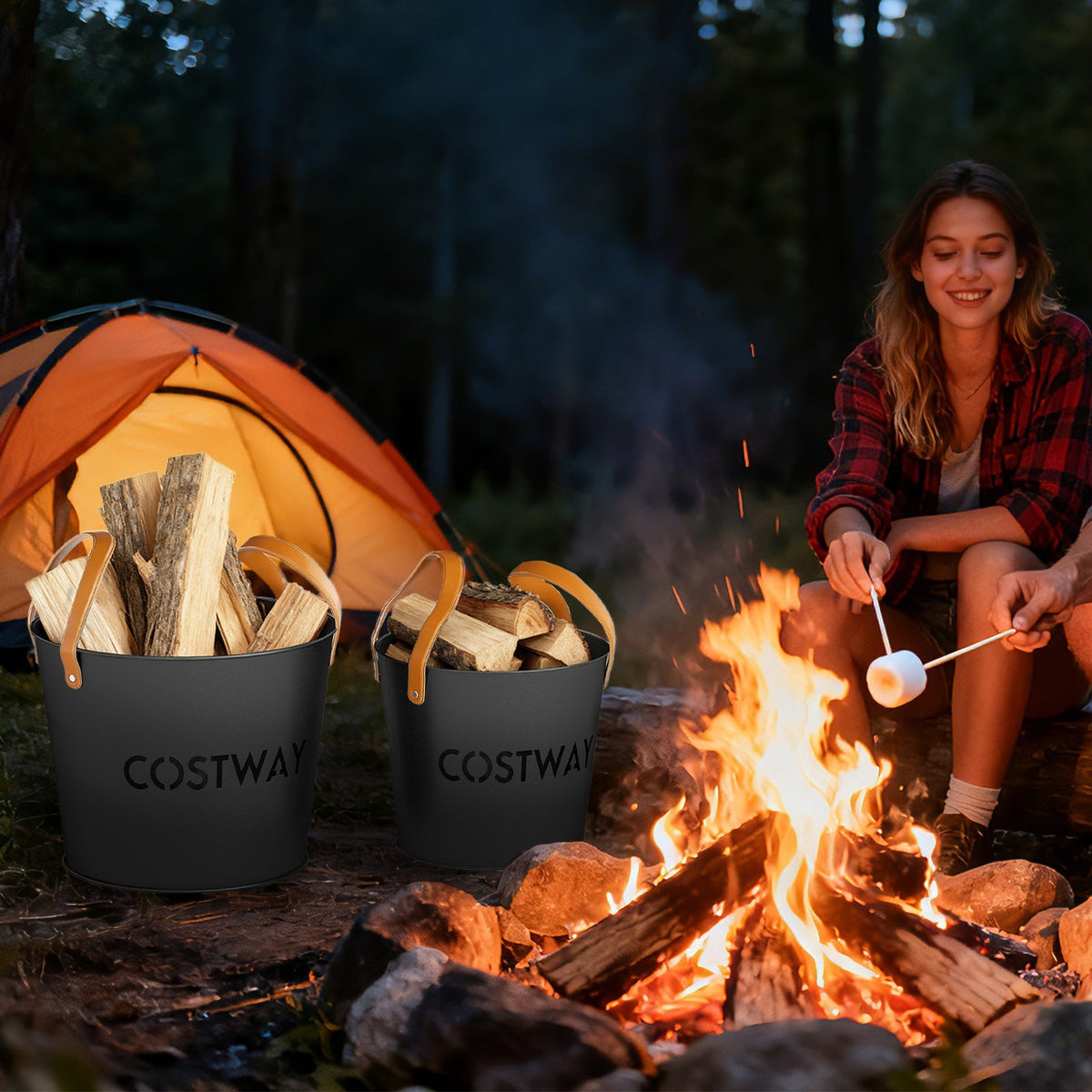 Two black metal ash buckets with tan handles beside a campfire with wood
