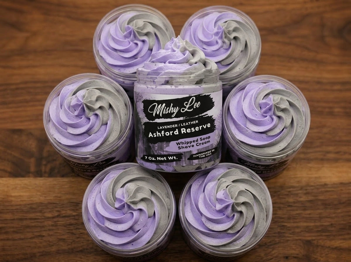 Five small jars of purple and gray whipped soap/shave cream arranged on wood
