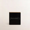 Black engraved candle with [NAME] text on square matte jar front