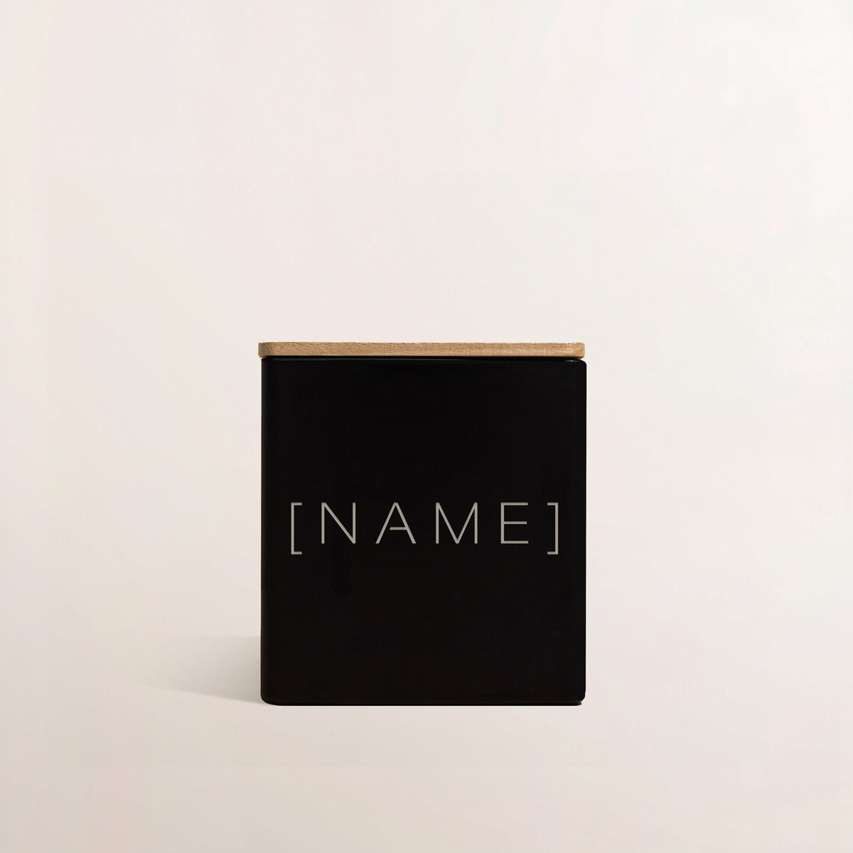Black engraved candle with [NAME] text on square matte jar front
