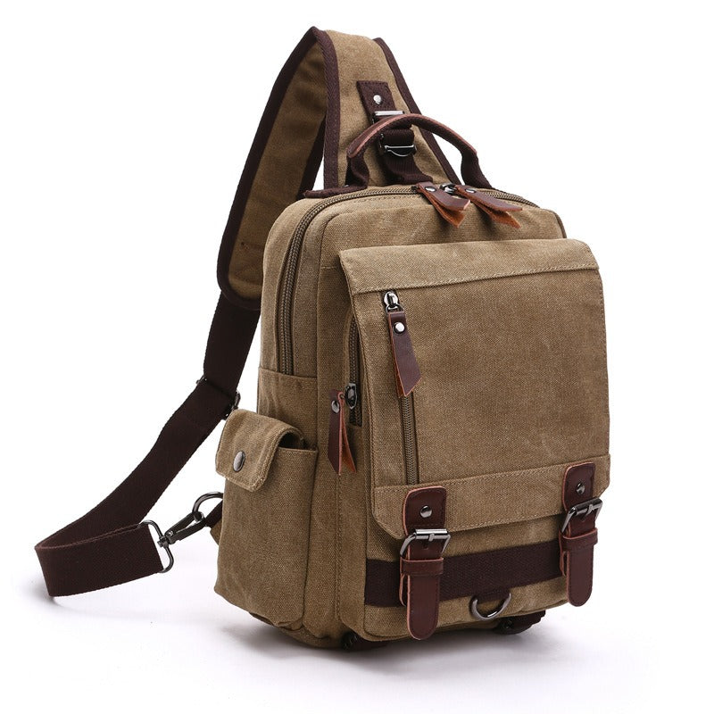 Tan canvas backpack with top handle, front flap pocket, and adjustable shoulder strap