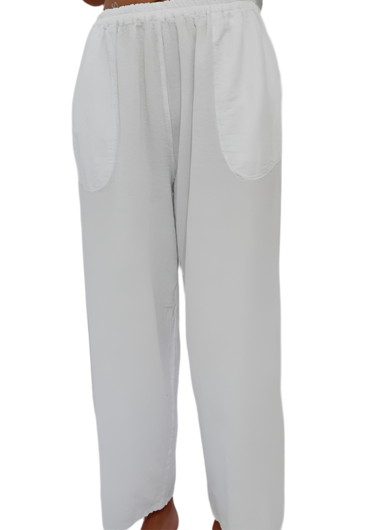 White cotton gauze pants with elastic waist, loose wide legs, and curved back pockets