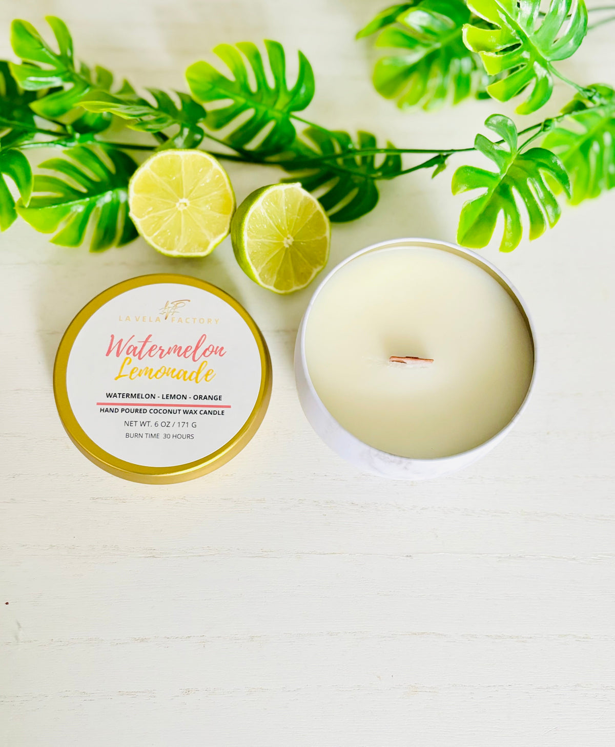 Wood-wick candle in gold tin with white wax; Watermelon Lemonade label visible.