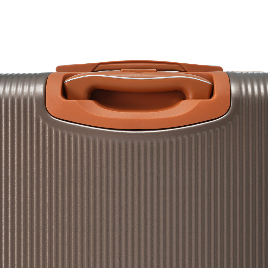 Copper-trimmed suitcase grab handle on ribbed hardshell frame