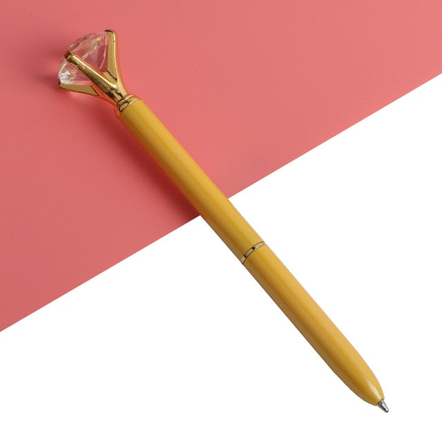 Gold gem-top metal ballpoint pen with faceted cap and smooth gold barrel