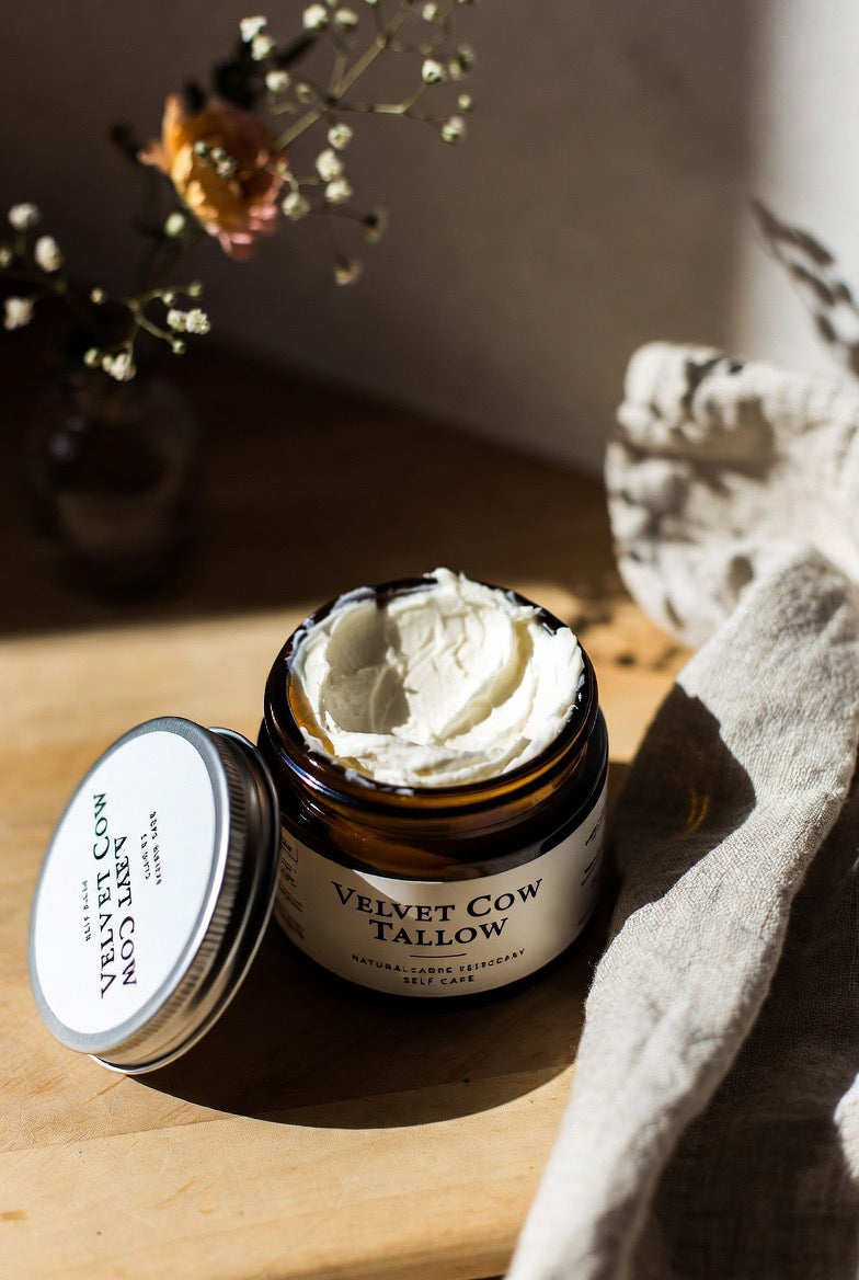 Open whipped tallow body butter jar with white whipped cream inside