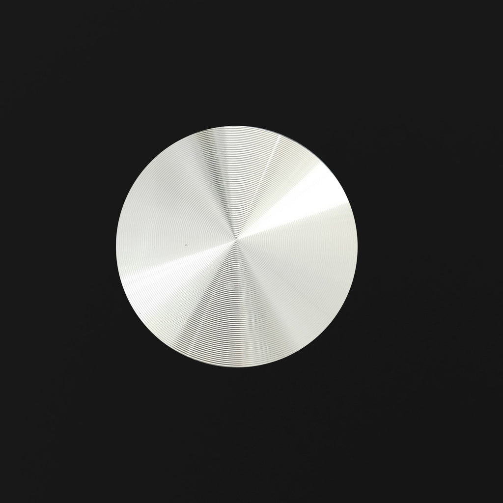 Glass tabletop surface finish close-up with circular highlight