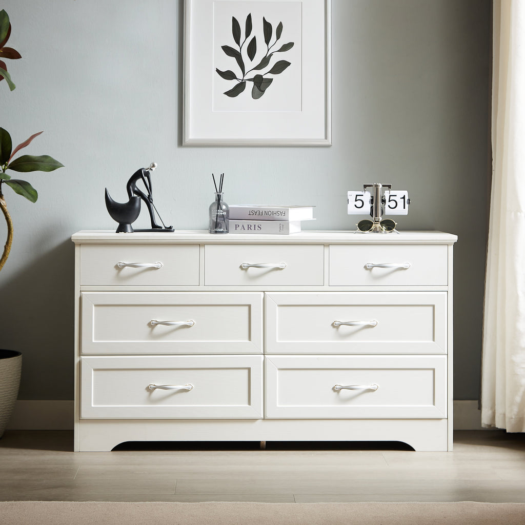 White dresser chest with drawers and chrome metal bar pulls, styled top