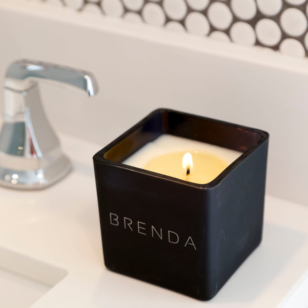 Lit black engraved candle with BRENDA name on front