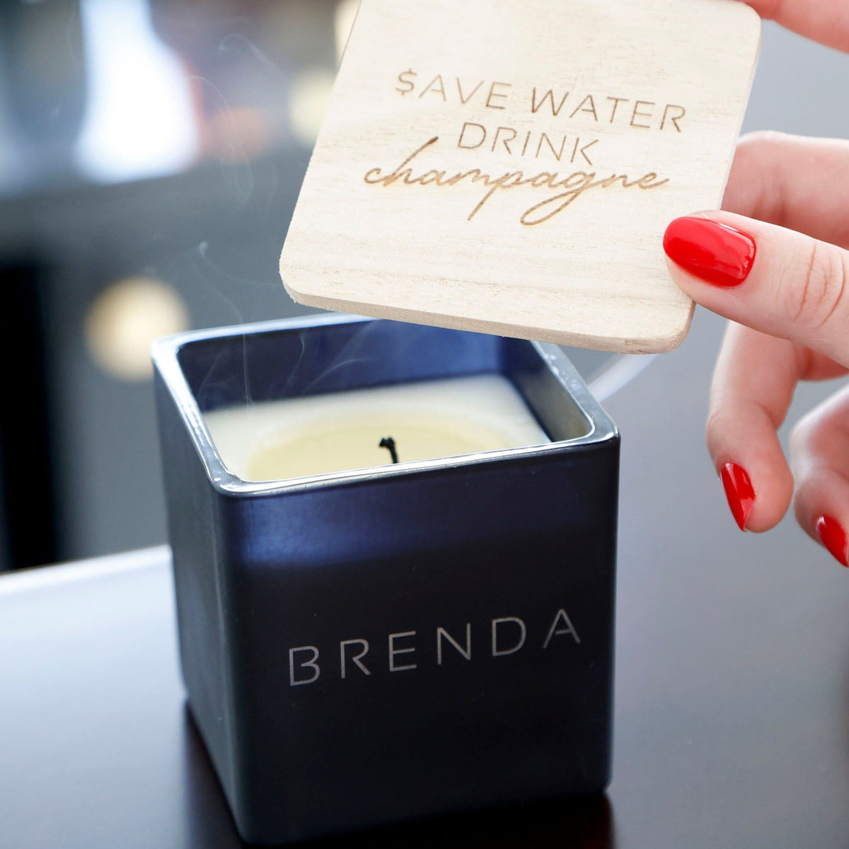 Black engraved candle with BRENDA and wooden SAVE WATER DRINK CHAMPAGNE tag