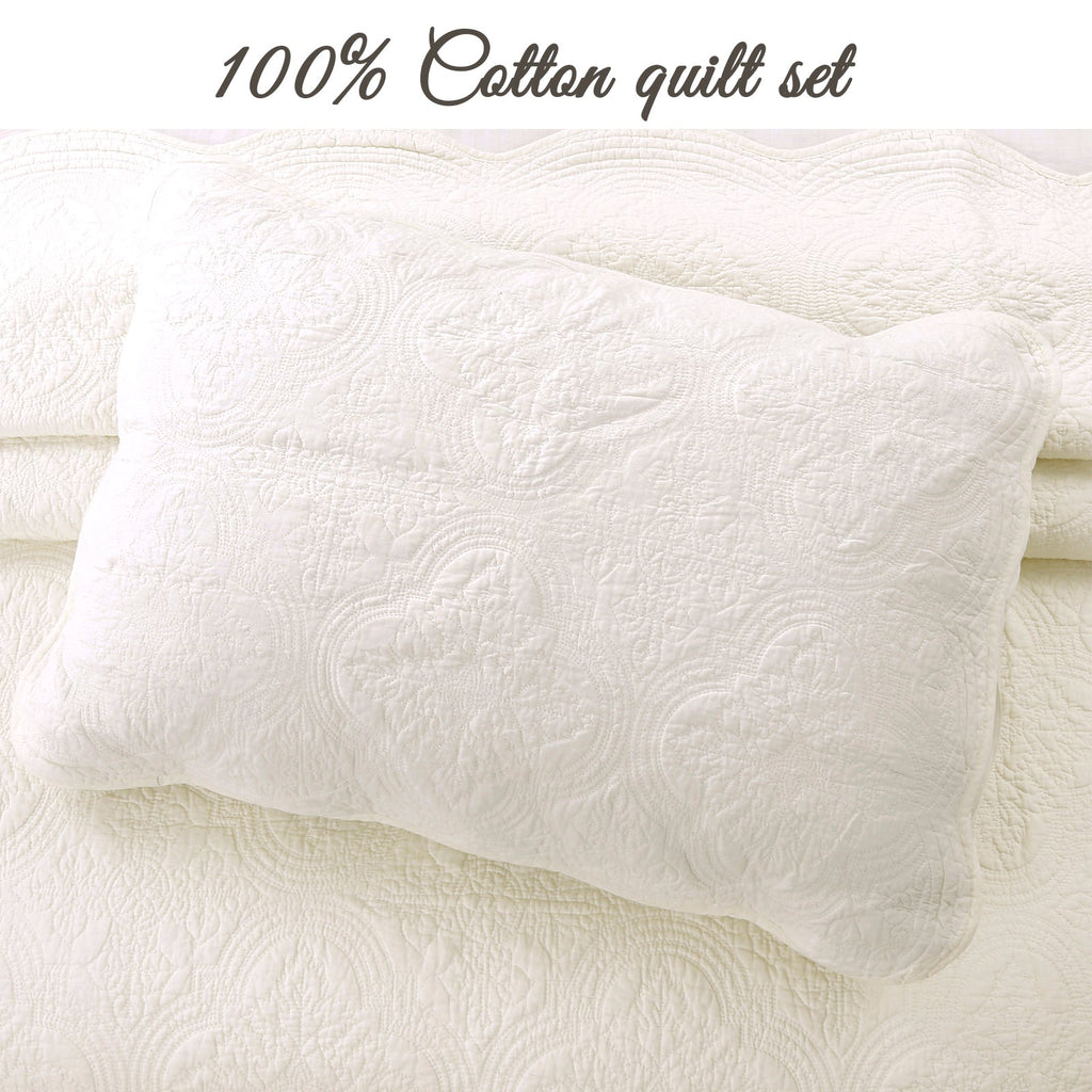 Ivory quilted pillow sham with embossed medallion swirl texture