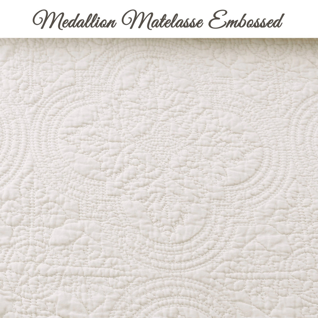 Ivory quilt surface with embossed medallion pattern and raised quilted texture