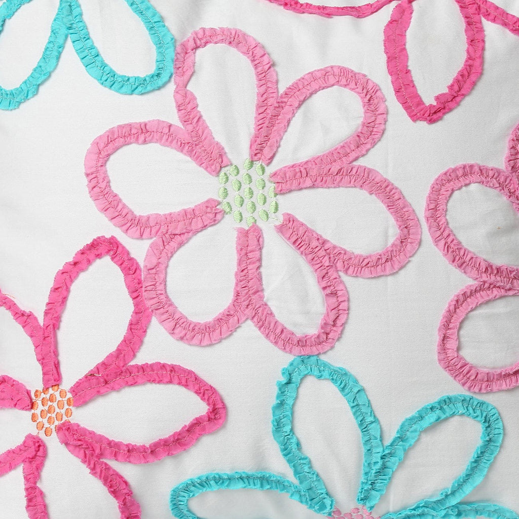 Decorative pillow from reversible quilt set with embroidered pink and blue floral loops