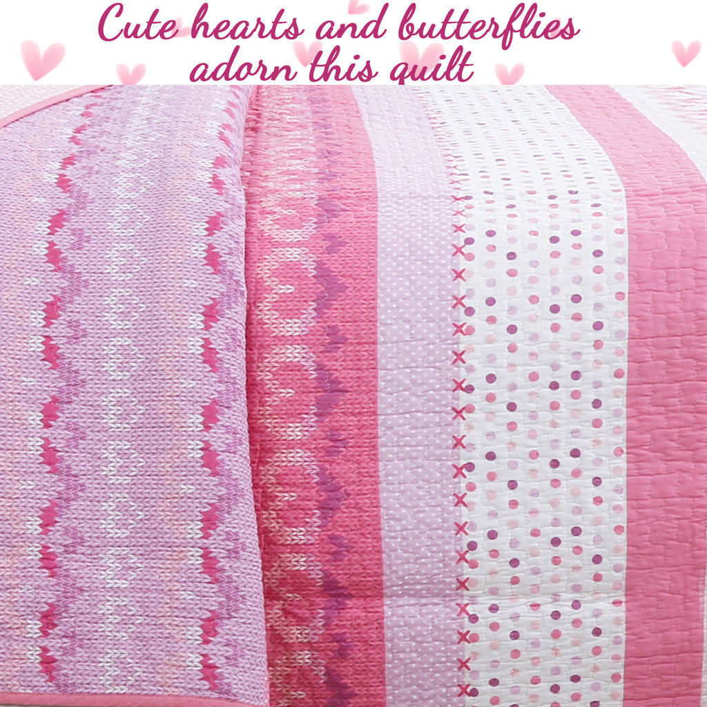 Pink and white reversible quilt with heart and butterfly motifs on striped panels