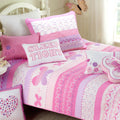 Reversible pink, purple and white quilt bedding set with patterned cover and pillows