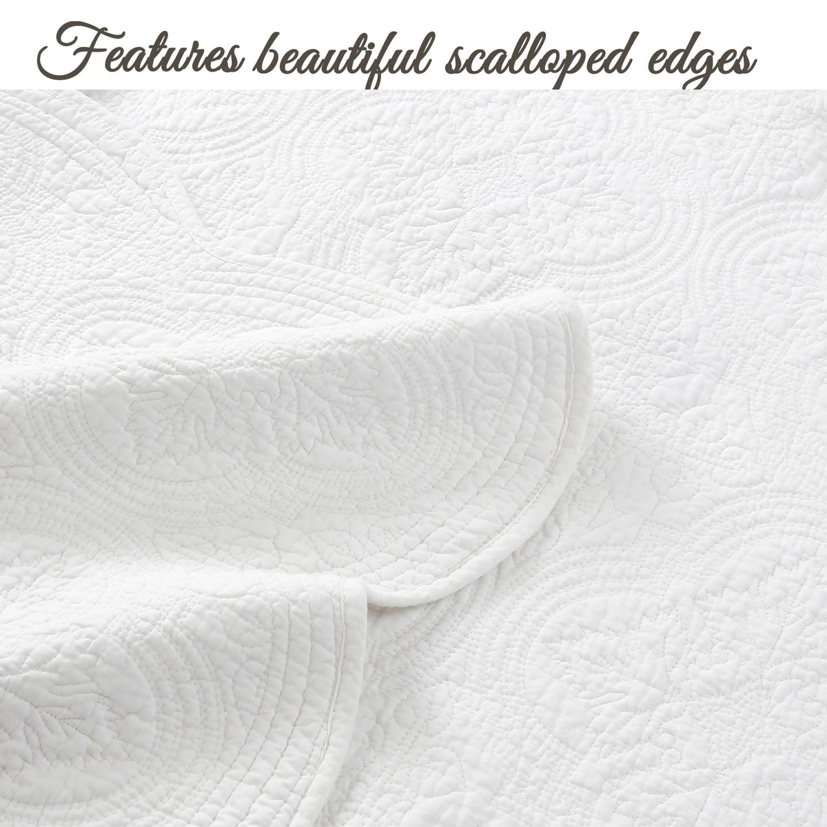 White quilt with scalloped edge trim and raised medallion quilt pattern