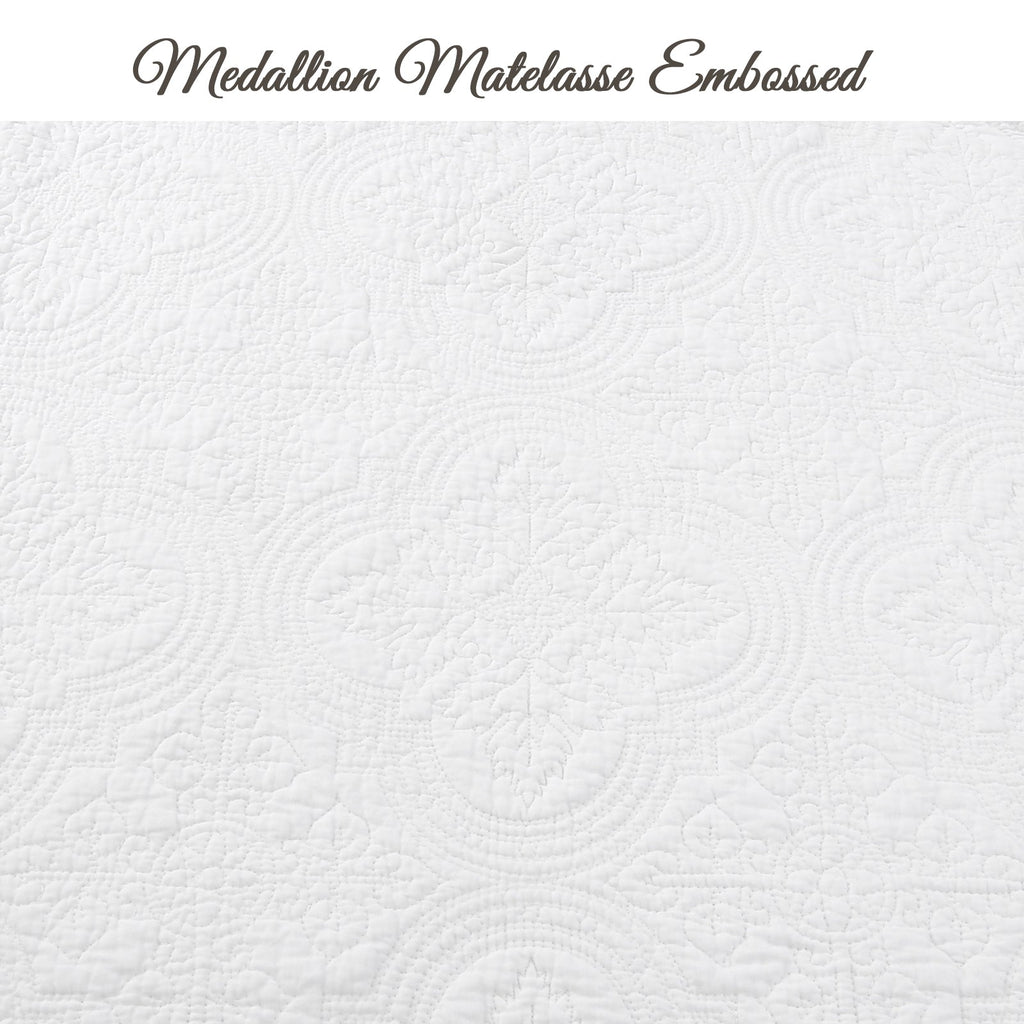 White quilt fabric detail with medallion matelasse embossed quilting