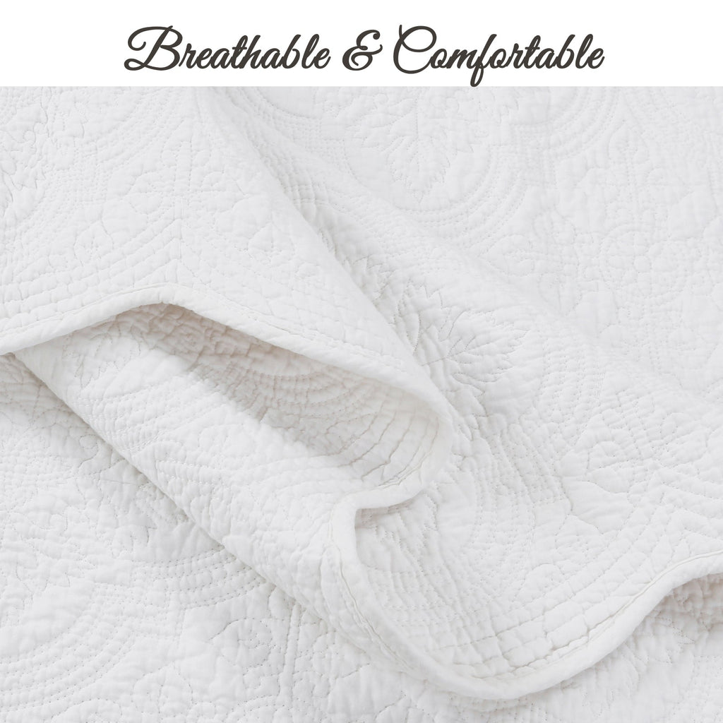 White quilt close-up showing soft stitched channels and allover medallion texture