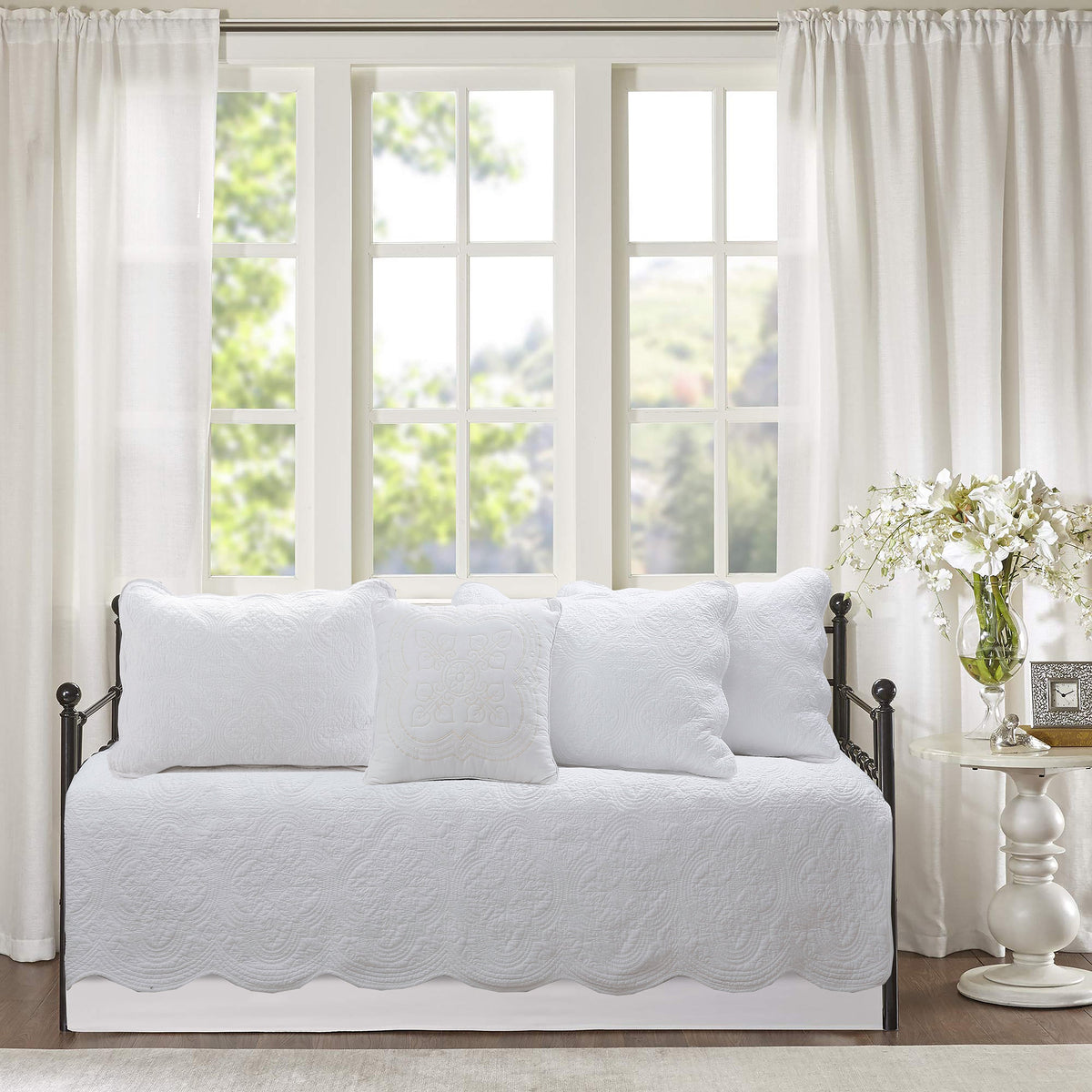 White quilted daybed bedding set with three decorative pillows