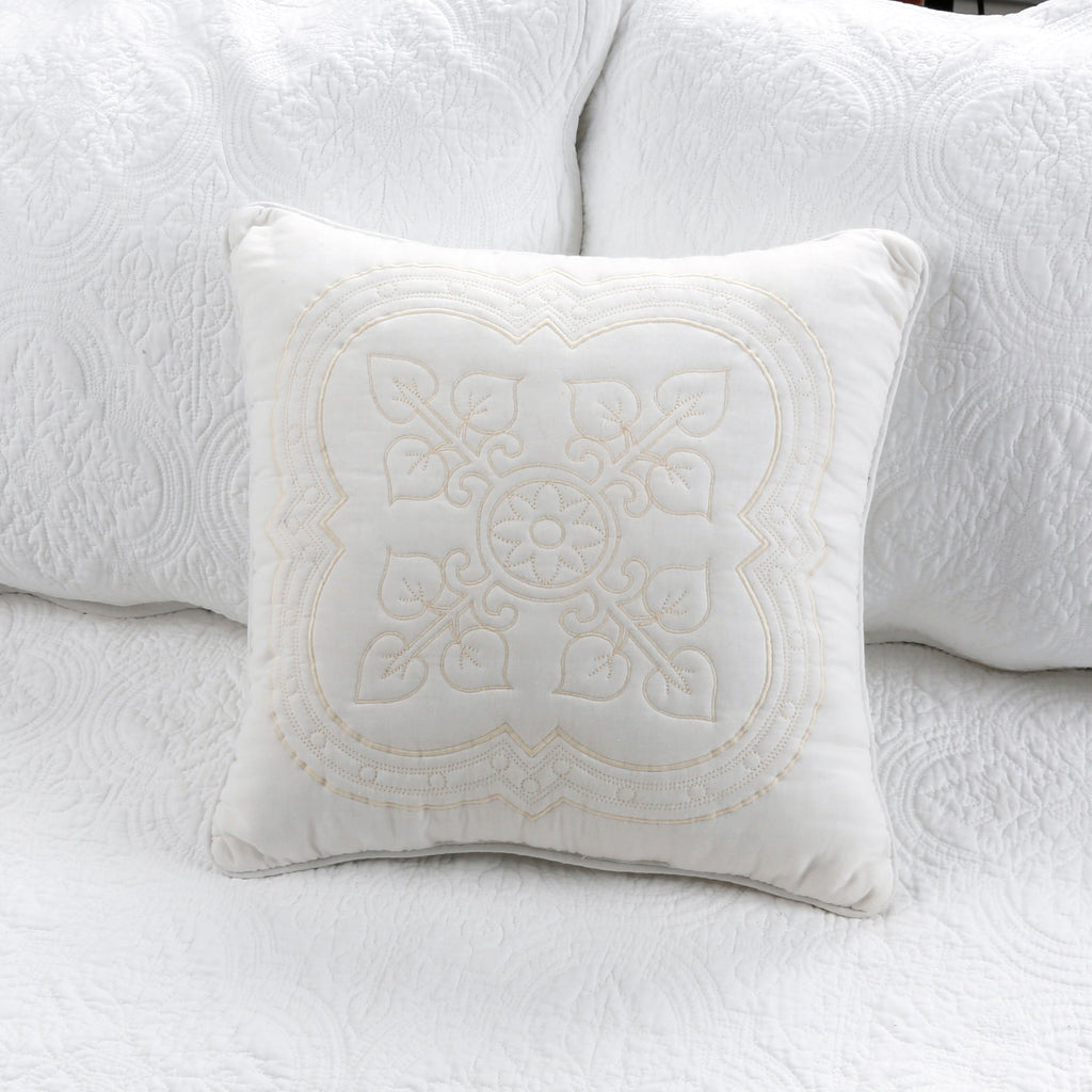 White quilted daybed bedding with decorative throw pillow and swirl texture