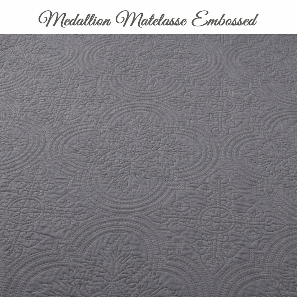 Gray quilt top with embossed medallion pattern texture across the fabric