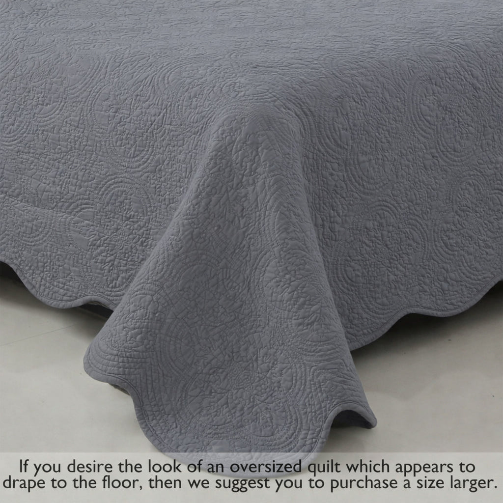 Gray quilt corner drape with medallion quilting texture and rounded edge detail