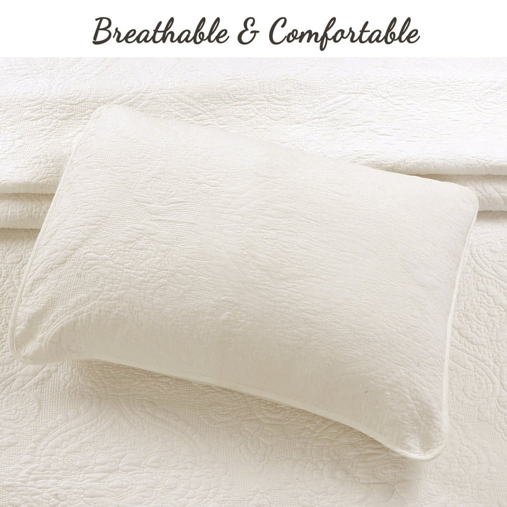 Ivory quilted pillow sham with soft medallion floral pattern and piped edge