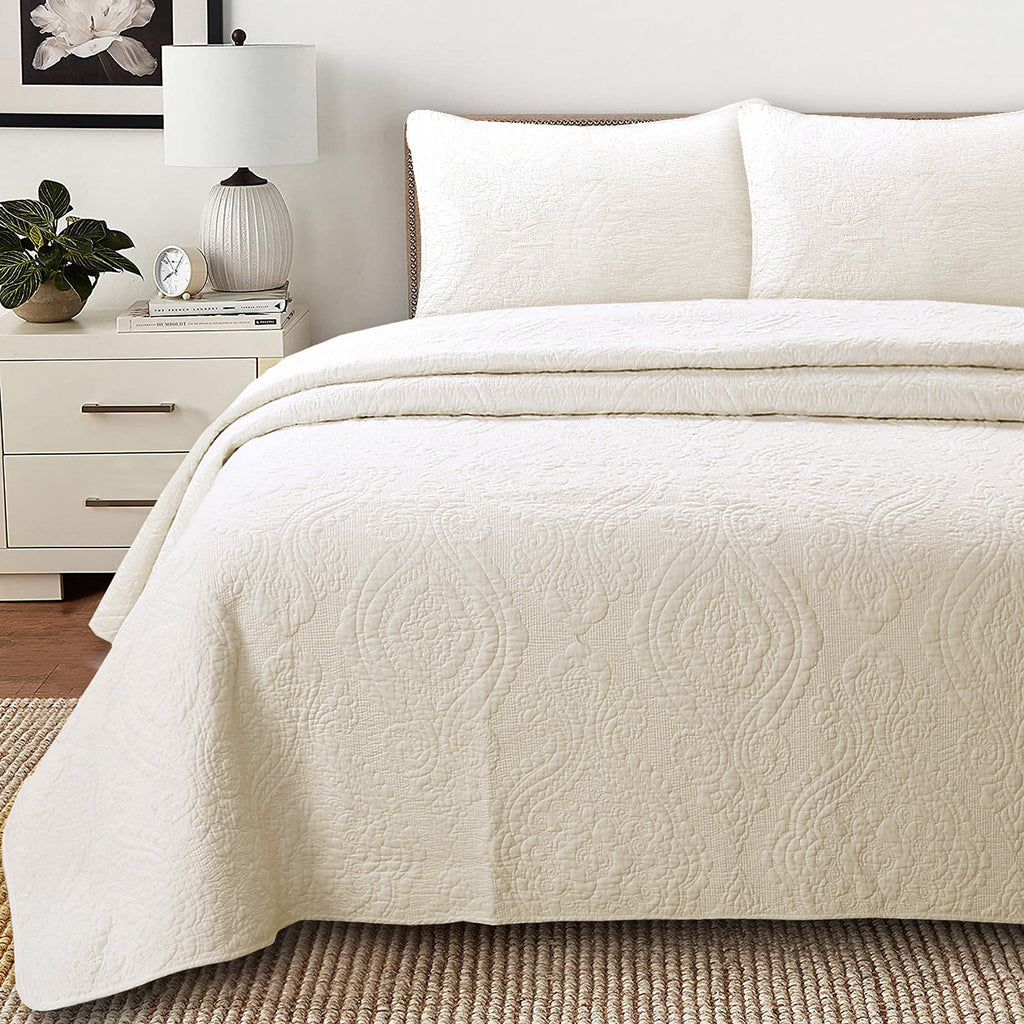 Ivory reversible cotton quilt bedding set with medallion floral quilting and matching shams