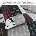 Reversible patchwork quilt with black, gray, red plaid, and deer/tree motifs