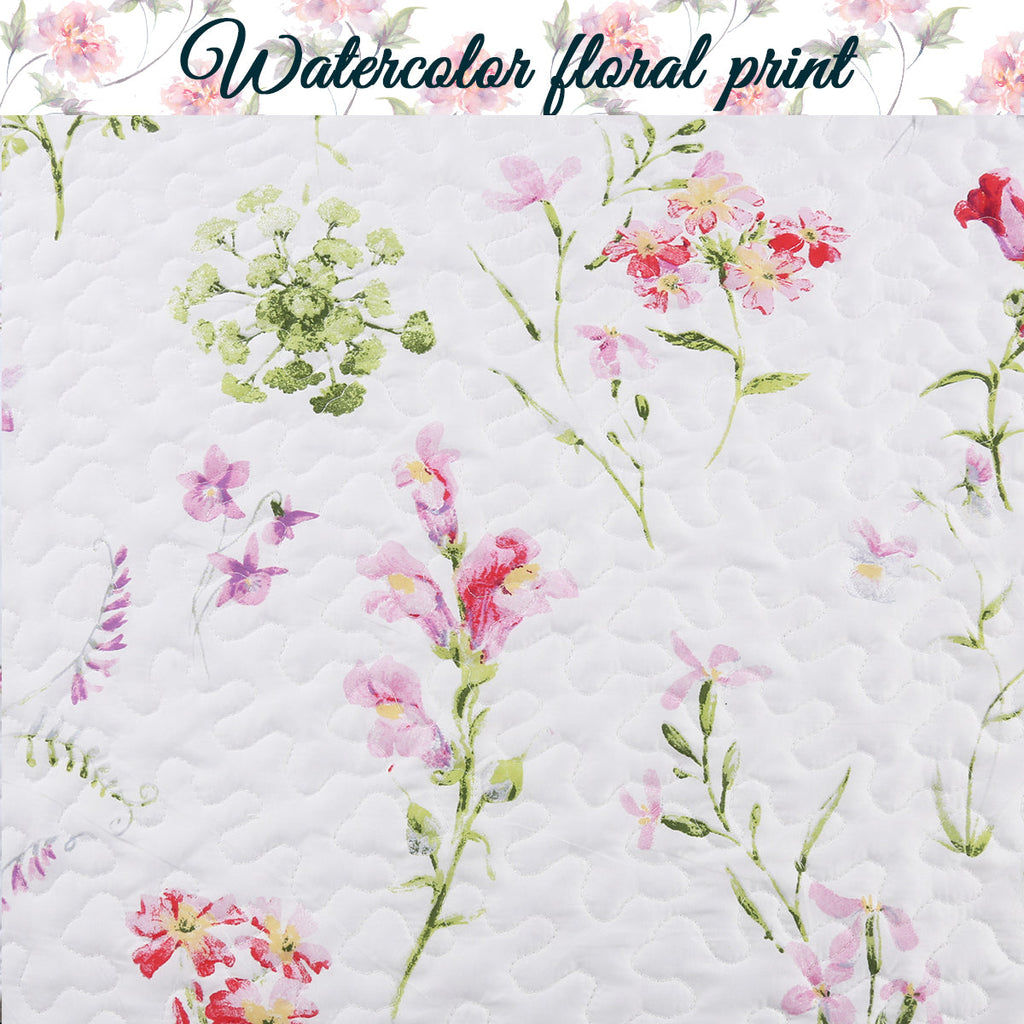 White quilted fabric with watercolor floral print in pink, green, and red accents