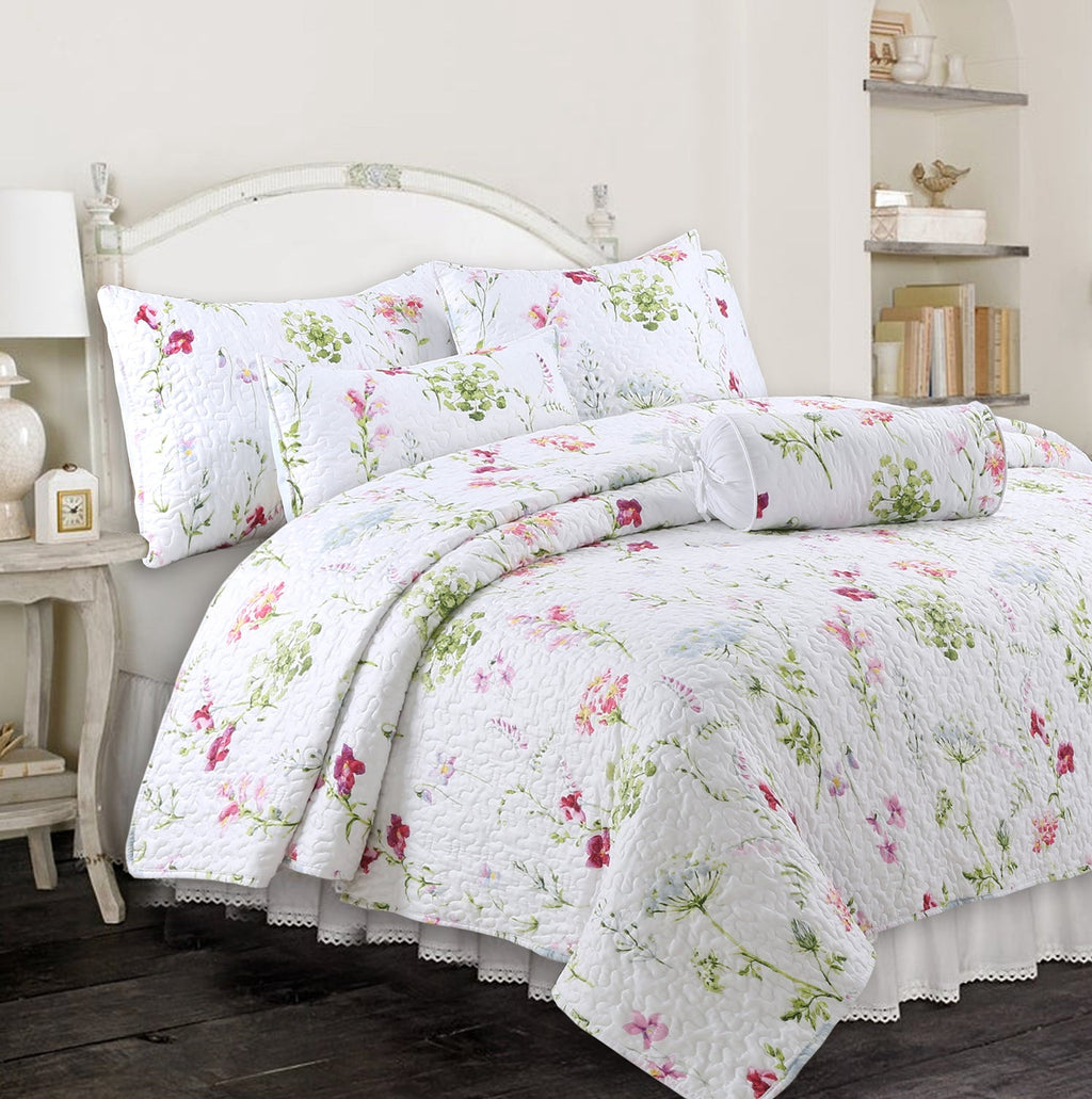 Floral throw pillows on bed, white with pink and green blossom print